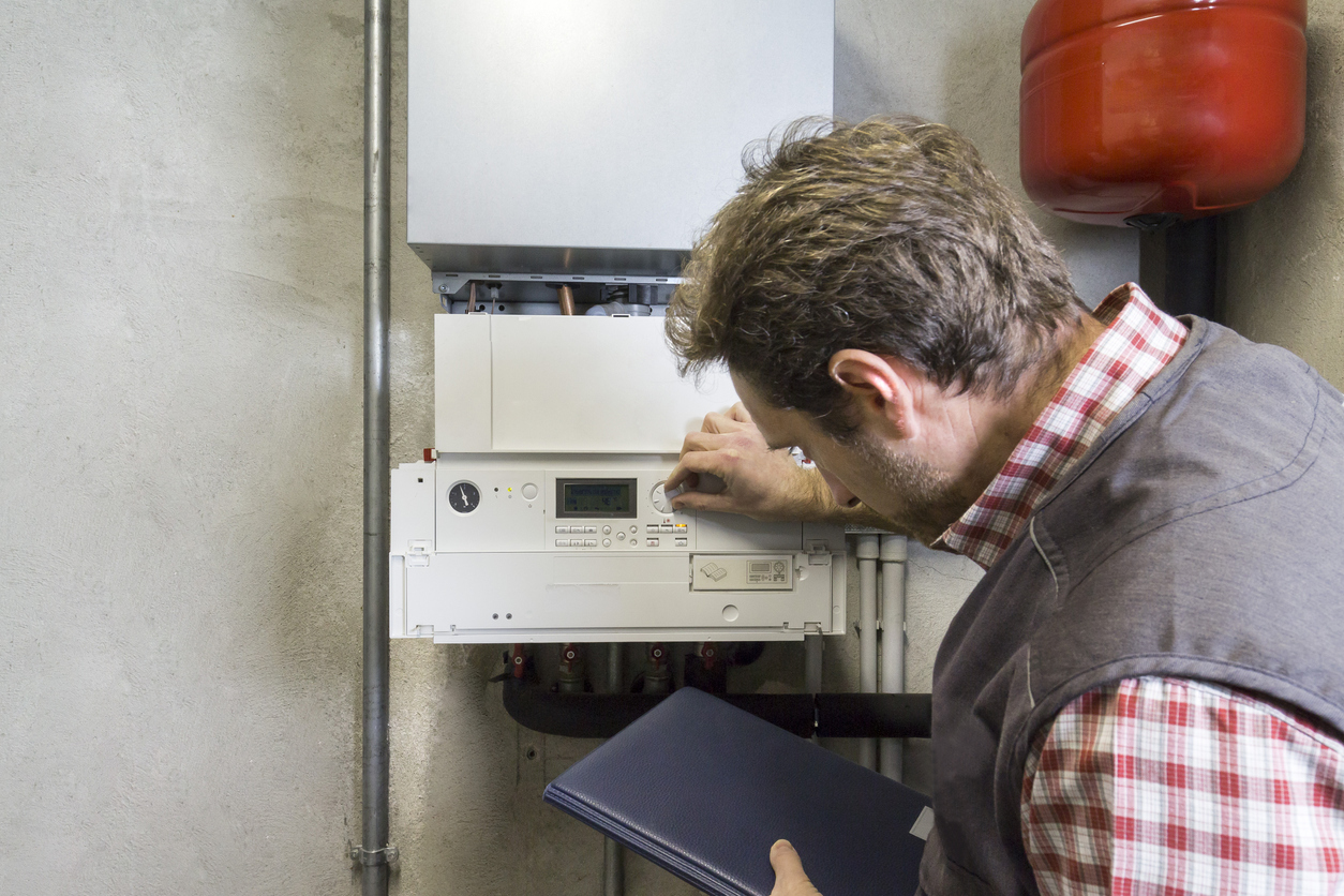 plumber repairing a condensing boiler plumber repairing a condensing boiler