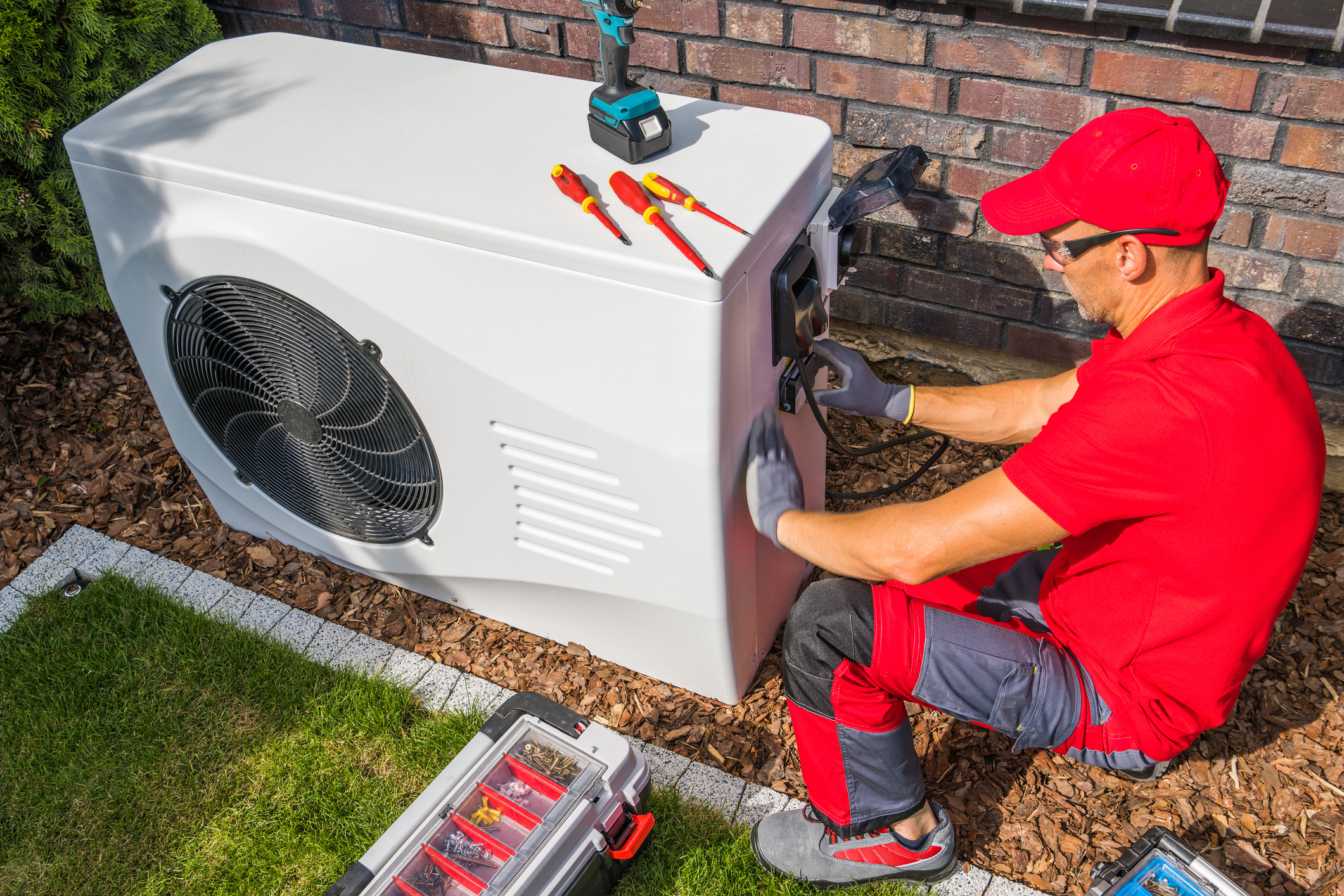 Technician Repairing Heat Pump Unit Technician Repairing Heat Pump Unit